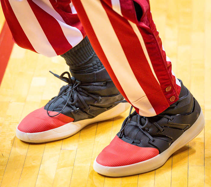 Side view of an Indiana Hoosiers basketball player's black and red adidas sneakers.